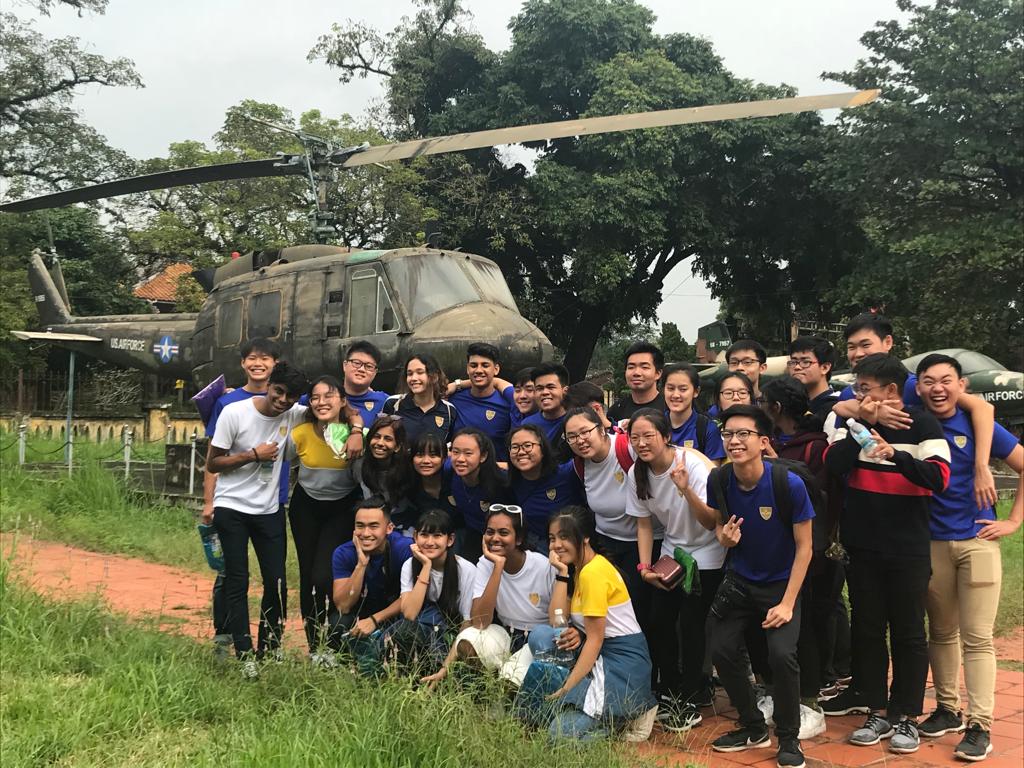 Posing in front of one of the many US Air Force Helicopters active during the War.jpeg